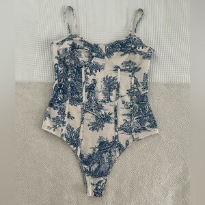 Womens CIDER bodysuit. Blue French style print. Size SMALL. Snap closure.